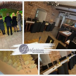 Restauracja Herbarium - Sala restauracyjna z ceglanymi ścianami, przygotowana na przyjęcie, z ustawionymi stołami, czarnymi krzesłami, świecami i kieliszkami z napojem, widoczni goście w tle, logo restauracji wkomponowane...