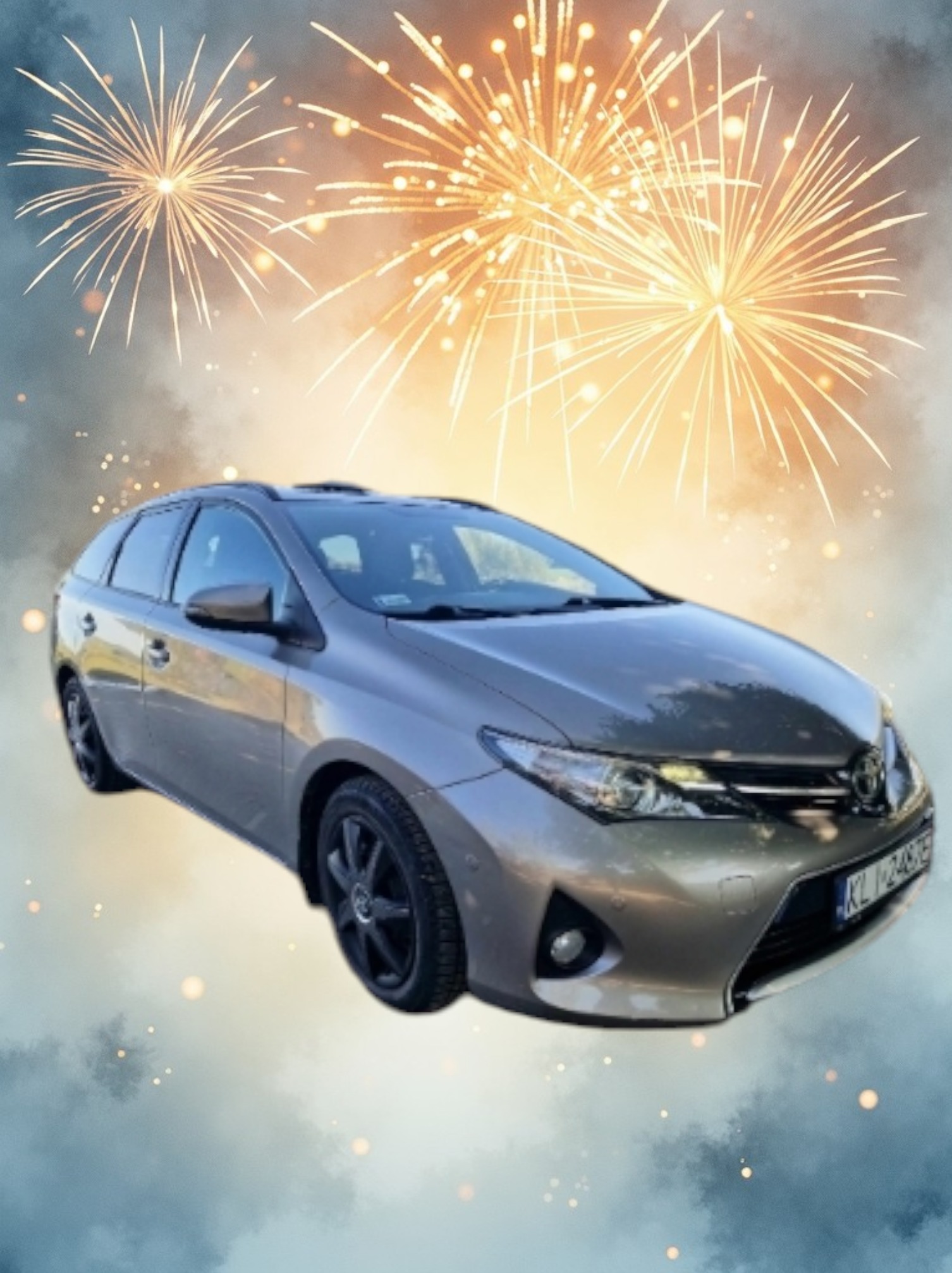 Szaro-złoty samochód kombi Toyota Auris na tle stylizowanym na fajerwerki i chmury.