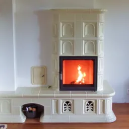 Biały, kaflowy piec z paleniskiem, płomienie widoczne przez szybę, drewno ułożone w dolnej wnęce, minimalistyczne wnętrze z drewnianą podłogą.