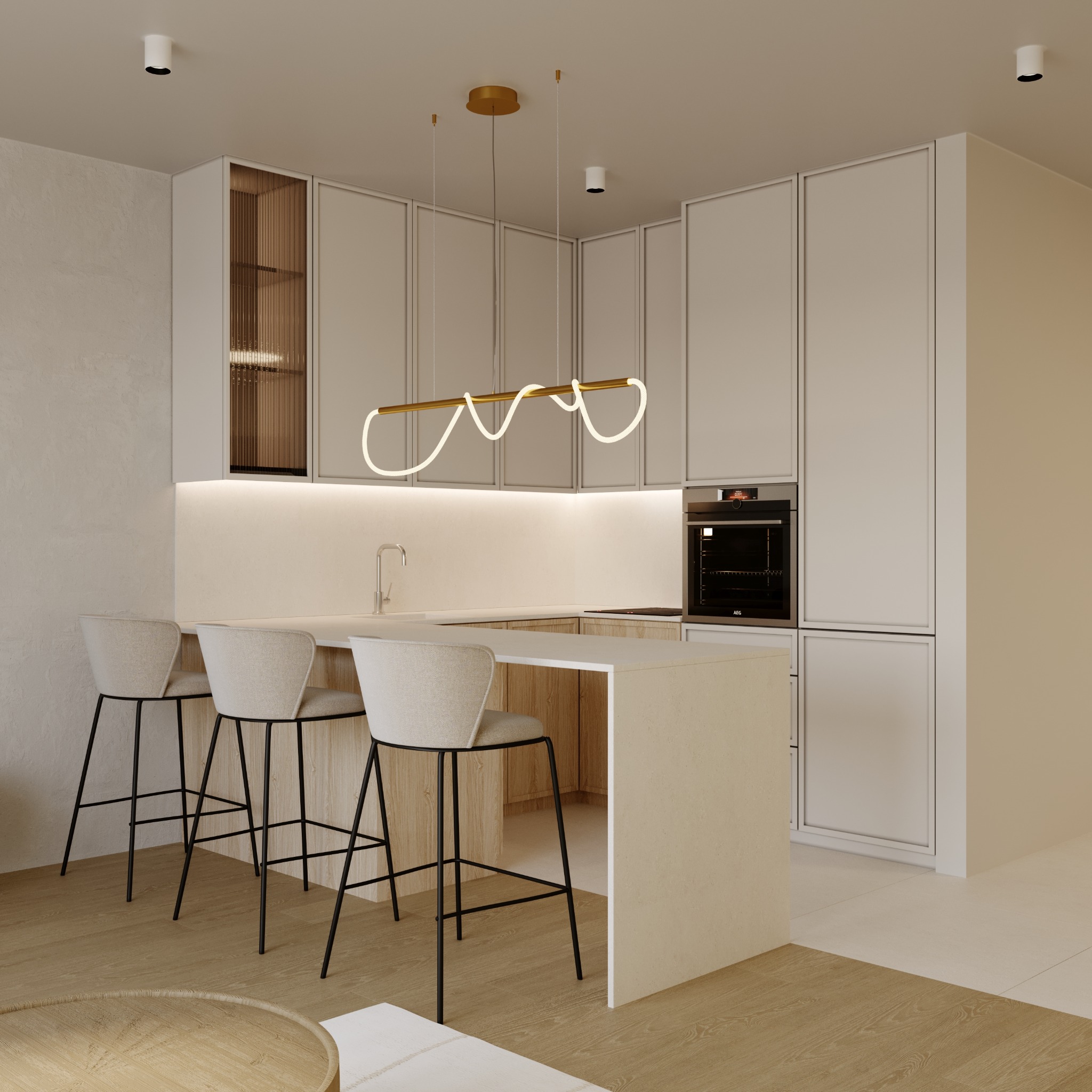 Minimalistyczna kuchnia z wyspą, oświetlona wiszącą lampą LED w złotym kolorze, z trzema beżowymi hokerami z czarnymi nogami, zabudowa kuchenna w jasnych odcieniach, z piekarnikiem w zabudowie...