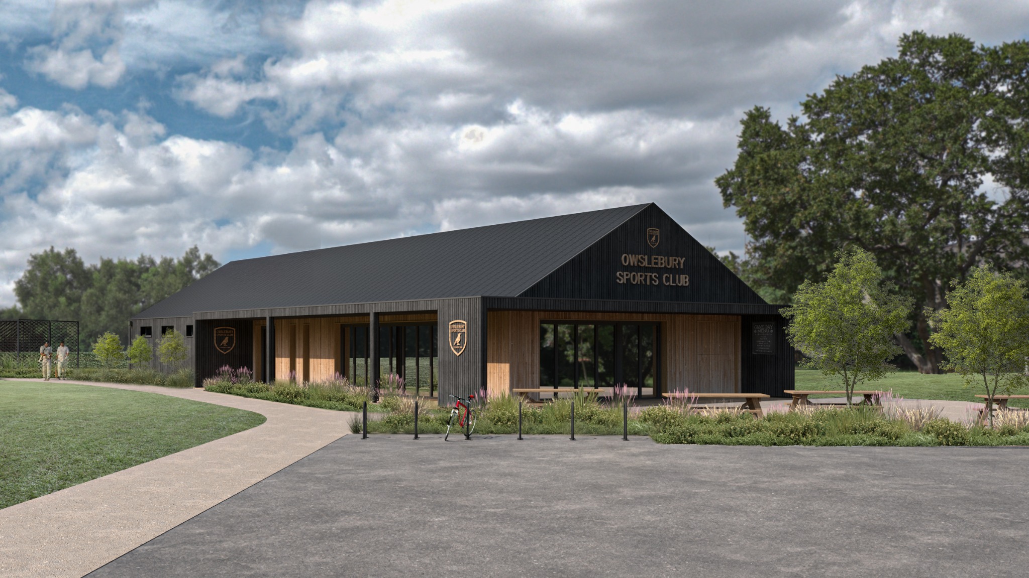 Wizualizacja budynku klubu sportowego 'Owslebury Sports Club' z czarną elewacją i drewnianymi elementami, otoczonego zielenią i ścieżką.
