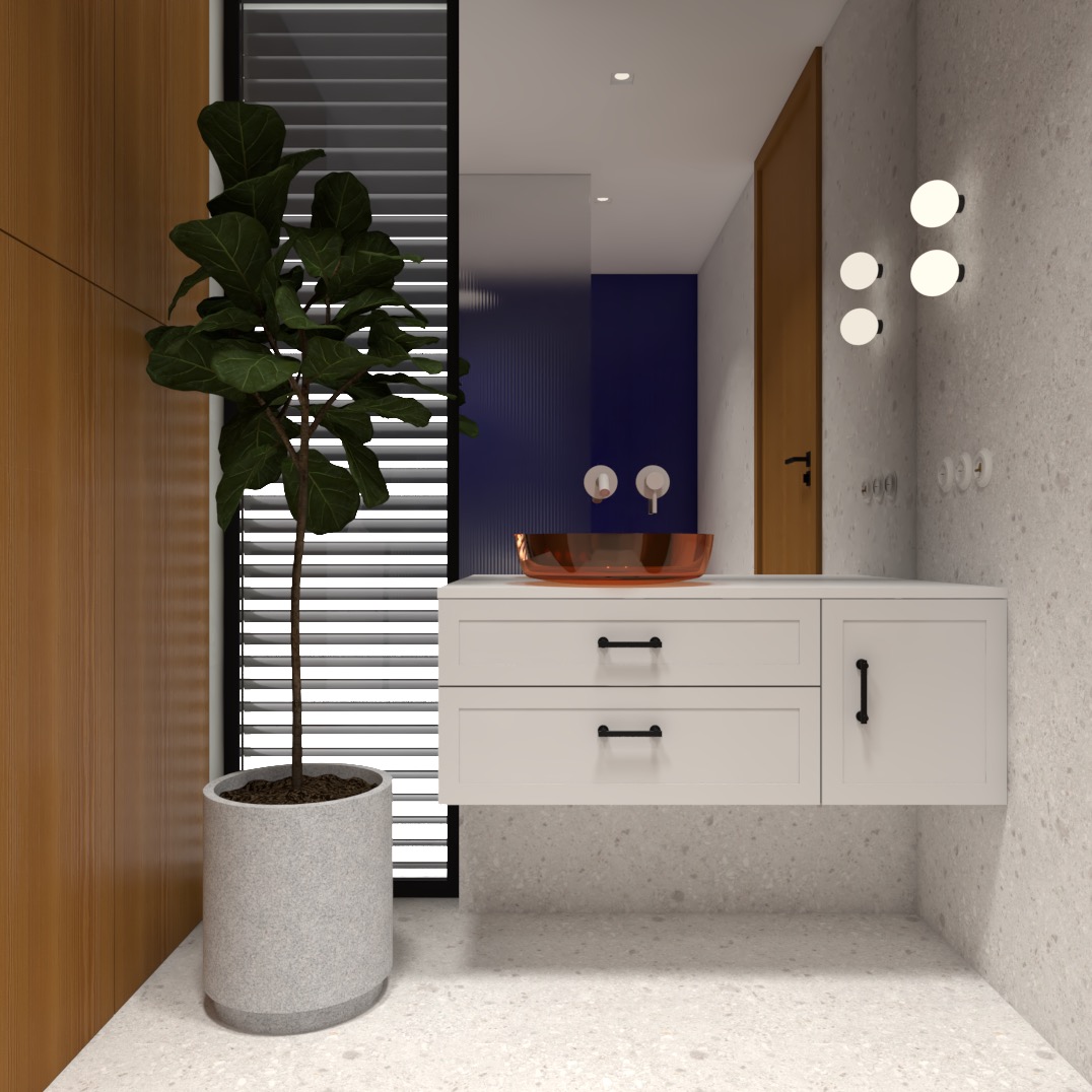 Nowoczesna łazienka z umywalką w odcieniach miedzi, białą szafką pod umywalką z czarnymi uchwytami, dekoracyjną rośliną w szarej donicy i niebieską ścianą w tle.