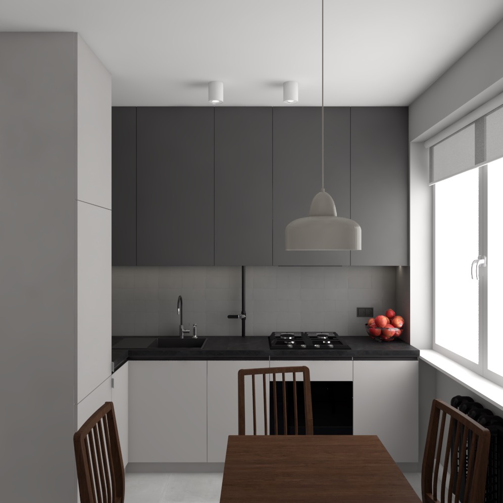 Minimalistyczna, nowoczesna kuchnia z szarymi szafkami górnymi i białymi dolnymi, czarnym blatem, drewnianym stołem z krzesłami i wiszącą lampą oświetlającą stół. Na blacie widoczna misa z jabłkami.