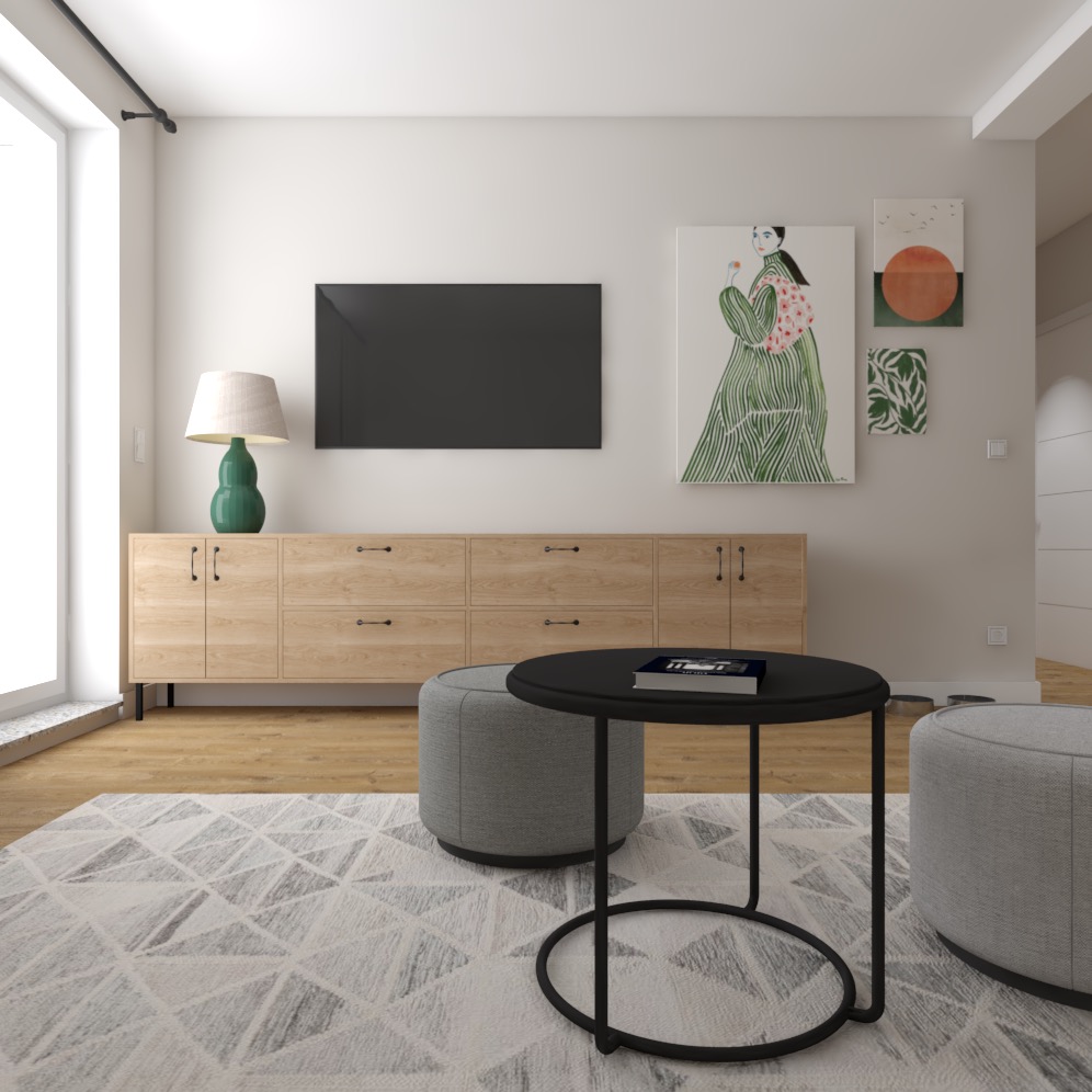 Jasne wnętrze salonu z drewnianą komodą pod telewizorem, okrągłym czarnym stolikiem kawowym i szarymi pufami na geometrycznym dywanie.