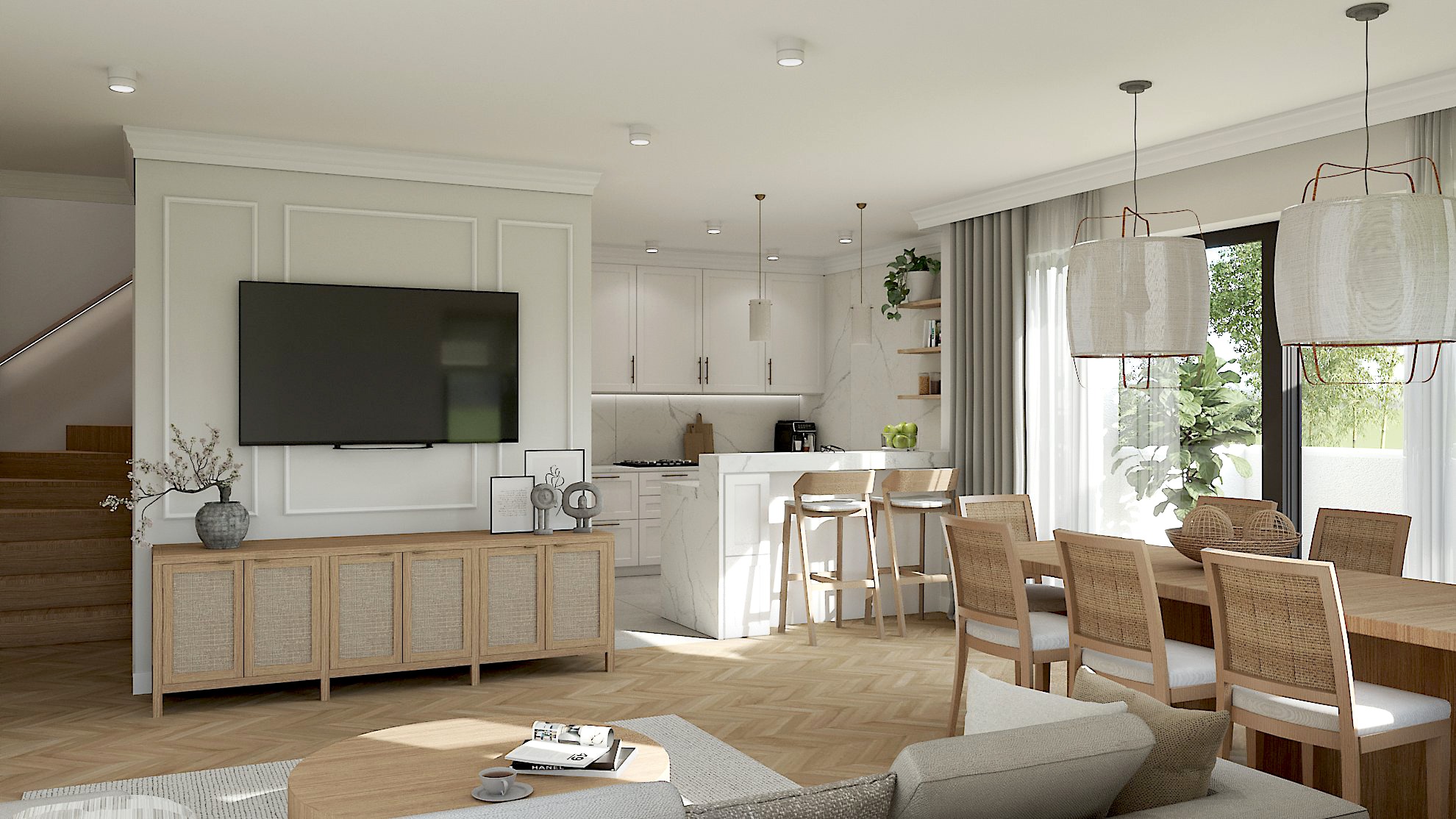 Jasne, przestronne wnętrze domu z otwartą kuchnią, jadalnią i salonem. Widoczny duży telewizor na ścianie z dekoracyjną sztukaterią, drewniana podłoga w jodełkę i nowoczesne oświetlenie.