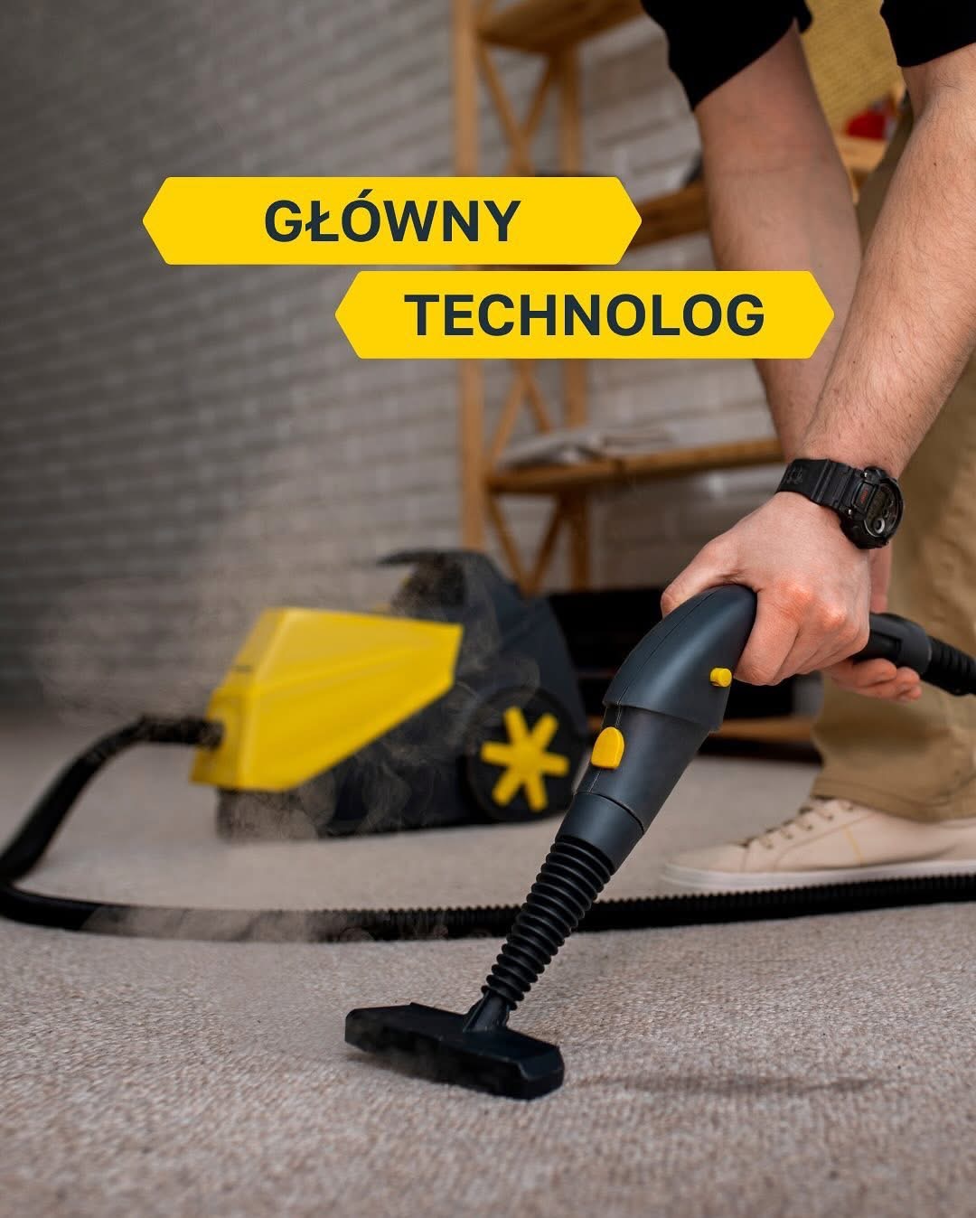 Czyszczenie dywanu parownicą: dłoń w zegarku prowadzi dyszę po jasnym dywanie, z tyłu żółto-czarny odkurzacz parowy. Para unosi się podczas pracy.