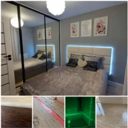 Nowoczesna sypialnia z ł&oacute;żkiem z podświetleniem LED, lustrzaną szafą i dekoracjami ściennymi. Widoczne detale wykończenia podłogi na dole zdjęcia.