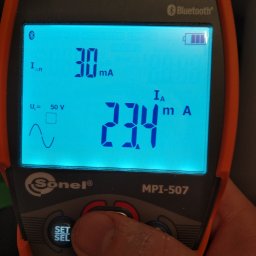 Marcin Włodarczyk Diagnosis - Miernik elektryczny Sonel MPI-507 z podświetlonym ekranem wskazującym wartości 30 mA i 23.4 mA, obsługiwany palcem na przycisku 'SET/SEL'.