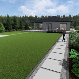 Harmonia Pracownia Projektowania Ogrodów - Wizualizacja ogrodu z nowoczesnym domem, trawnikiem, ścieżką z płyt, rabatami kwiatowymi i drzewami w tle. Osoba spaceruje po ścieżce. Projekt z dbałością o detale.
