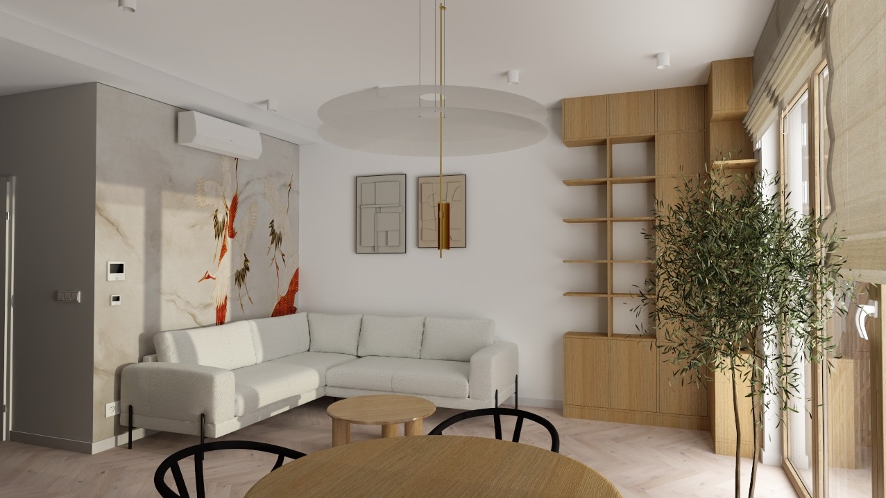 Jasne wnętrze salonu z narożną sofą, okrągłym stolikiem kawowym i drewnianą zabudową z półkami. Na ścianie dekoracyjny motyw żurawi. Minimalistyczny design z rośliną doniczkową.