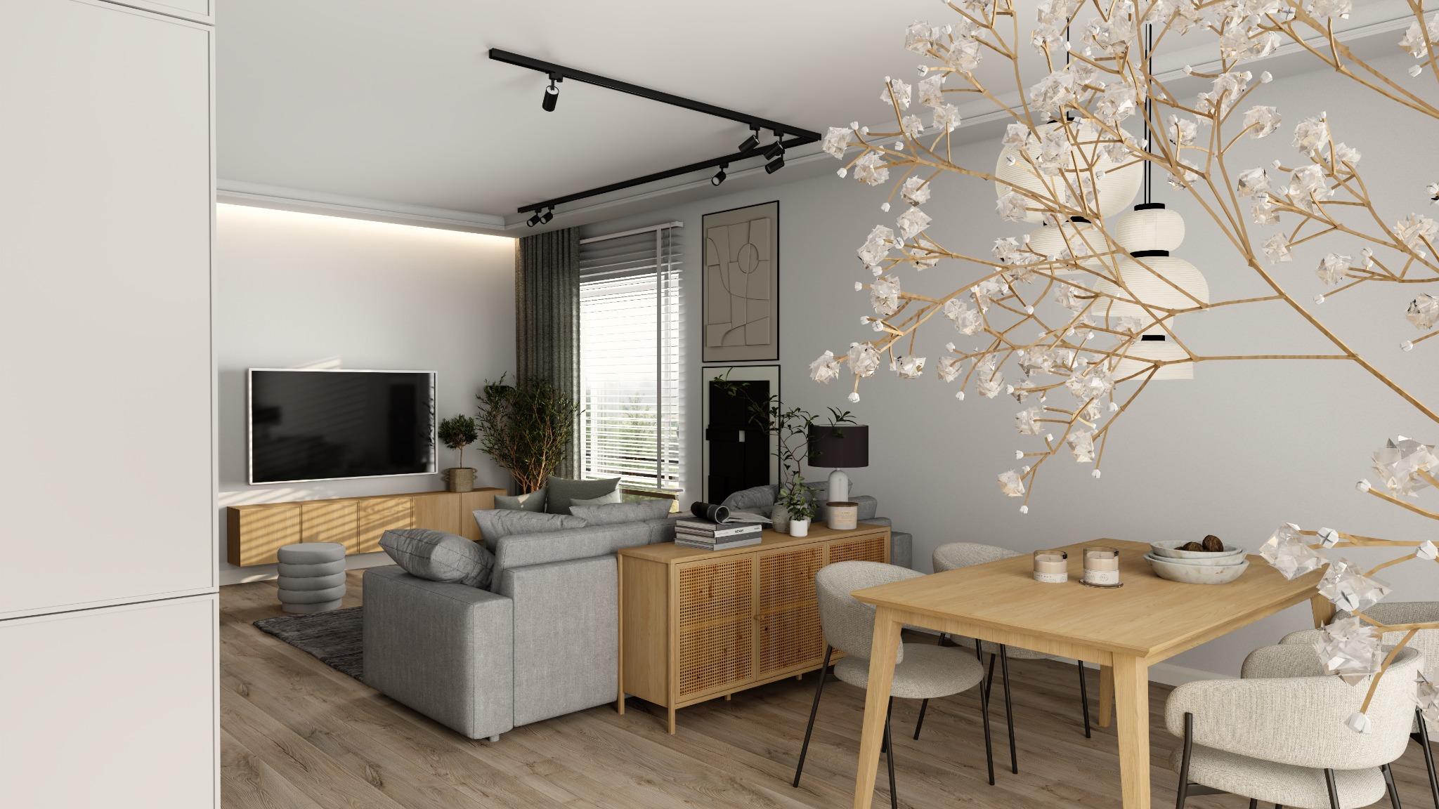 Jasne wnętrze salonu z jadalnią. Szara sofa, drewniany stół z krzesłami, dekoracyjna lampa z gałązek. Minimalistyczny design, oświetlenie punktowe.