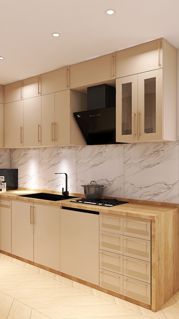 Beżowa kuchnia z marmurowym backsplashiem, czarnym zlewem i okapem. Uwagę przykuwają złote uchwyty szafek i drewniany blat, dodające elegancji. Nowoczesny design.