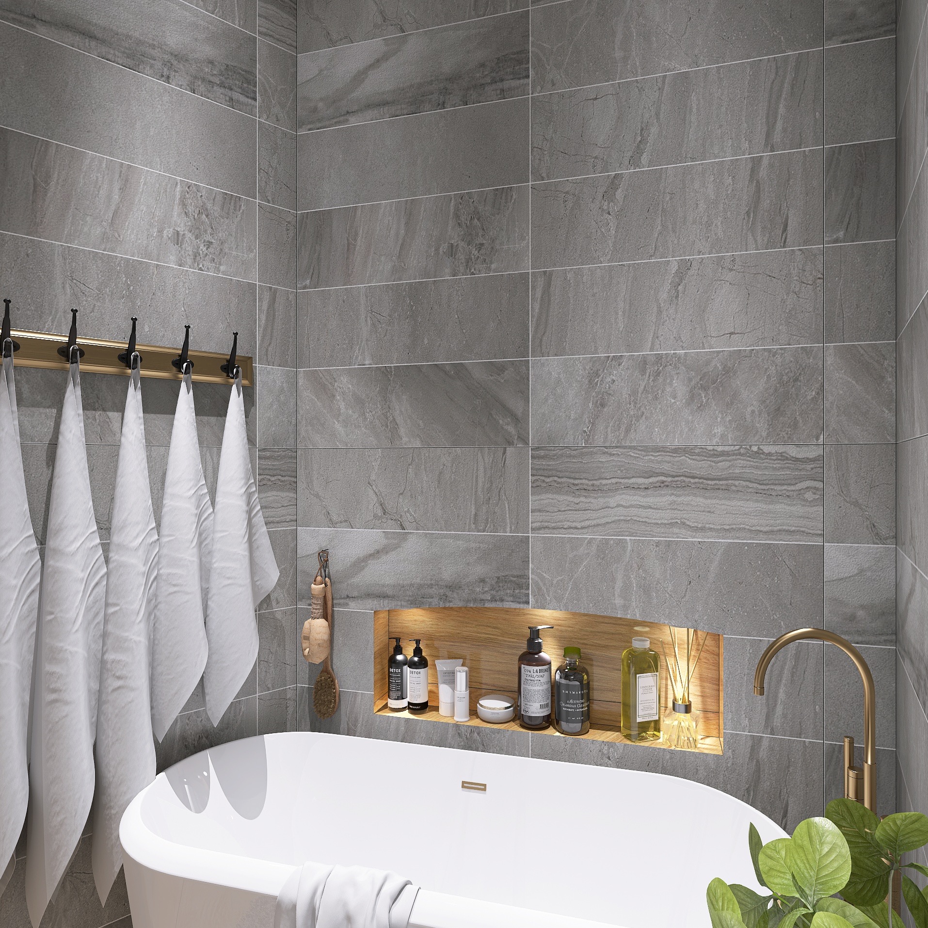 Elegancka łazienka z wanną wolnostojącą, szarą płytką imitującą kamień i złotymi akcentami: bateria, haczyki na ręczniki, półka z oświetleniem.