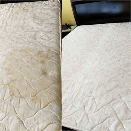 ... - Porównanie: widoczna różnica w czystości materaca przed i po czyszczeniu, z wyraźnymi plamami na lewej połowie i odświeżonym wyglądem na prawej.