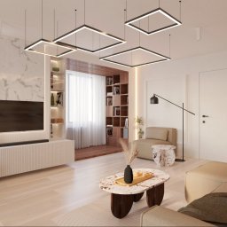 HAN architecture studio - Nowoczesny salon z marmurową ścianą, geometrycznymi lampami sufitowymi i drewnianym regałem z książkami, beżowa kolorystyka, marmurowy stolik kawowy z dekoracyjnym wazonem.