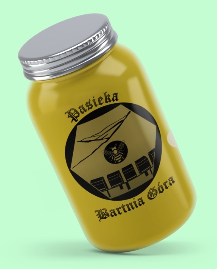 Żółty słoik z miodem z czarnym, okrągłym logo przedstawiającym ul i pszczołę, opatrzony napisem 'Pasieka Bartnia Góra'.
