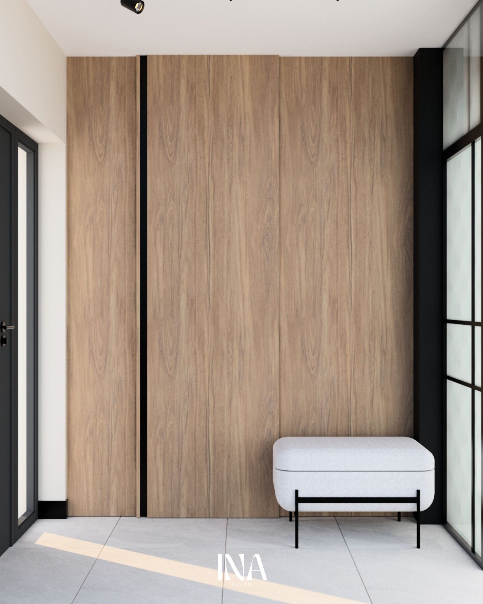 Nowoczesny przedpokój z drewnianą zabudową szafy, czarnymi akcentami i białą pufą. Minimalistyczny design, jasne płytki podłogowe, punktowe oświetlenie.