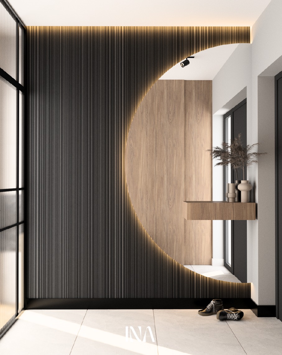 Nowoczesny przedpokój z panelami ściennymi w odcieniach szarości i drewna, oświetleniem LED i minimalistyczną konsolą. Na podłodze leżą buty, dodając wnętrzu życia.