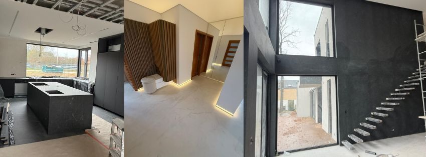 Wnętrze w trakcie wykończenia: kuchnia z wyspą, łazienka z drewnianą ścianką i korytarz ze schodami. Widoczne elementy instalacji i oświetlenia.