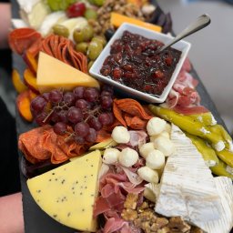 Motorsport Location Catering Ltd - Deska serów i wędlin z owocami, orzechami i konfiturą, serwowana na czarnym łupku.