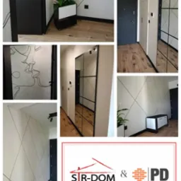 Nowoczesny przedpokój po wykończeniu: białe ściany z czarnymi, geometrycznymi liniami, lustro w czarnej ramie, drewnopodobne panele, czarne drzwi i dekoracje.