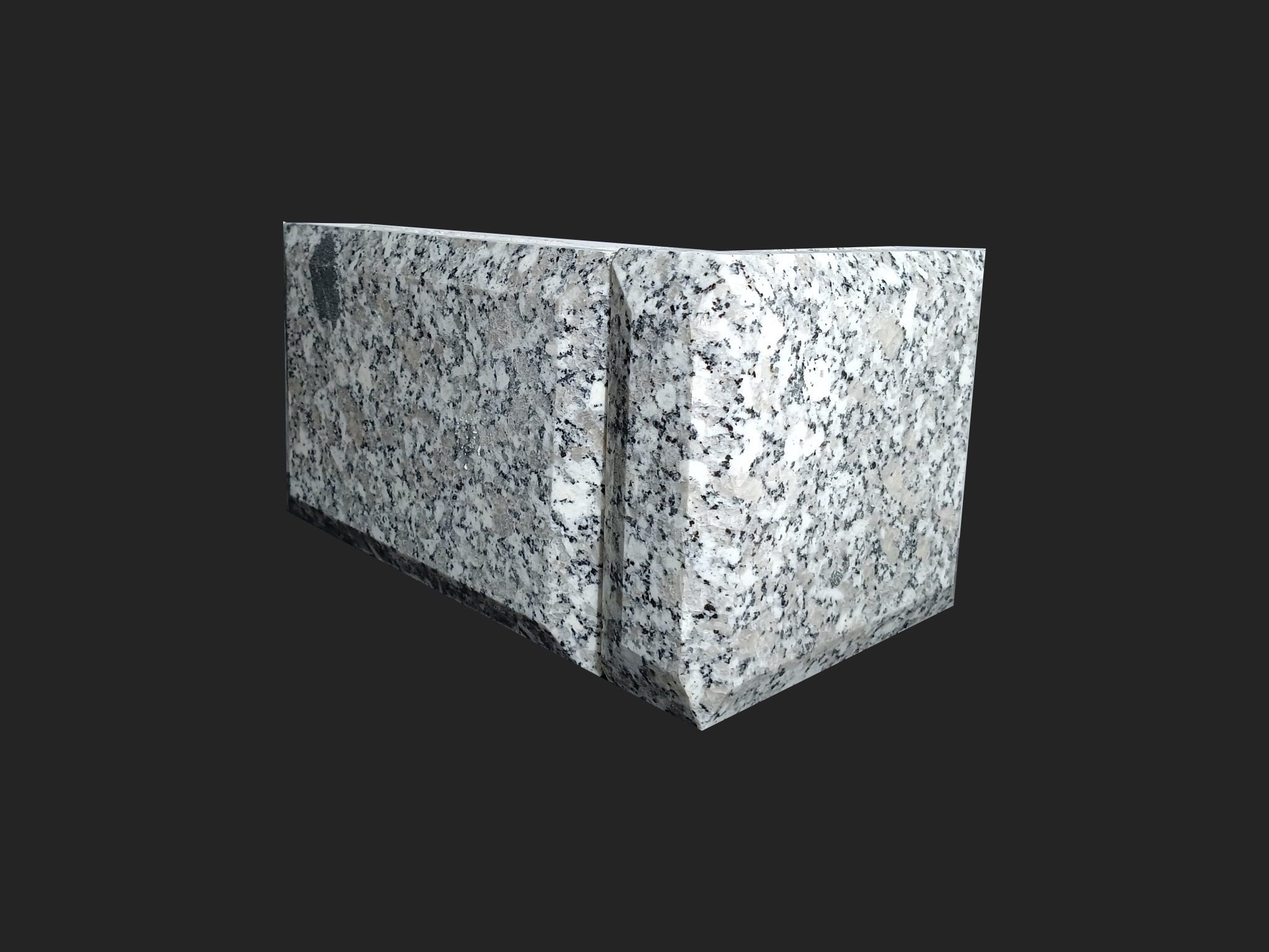 Narożny element wykończeniowy z jasnego, nakrapianego konglomeratu, widoczny na ciemnym tle.