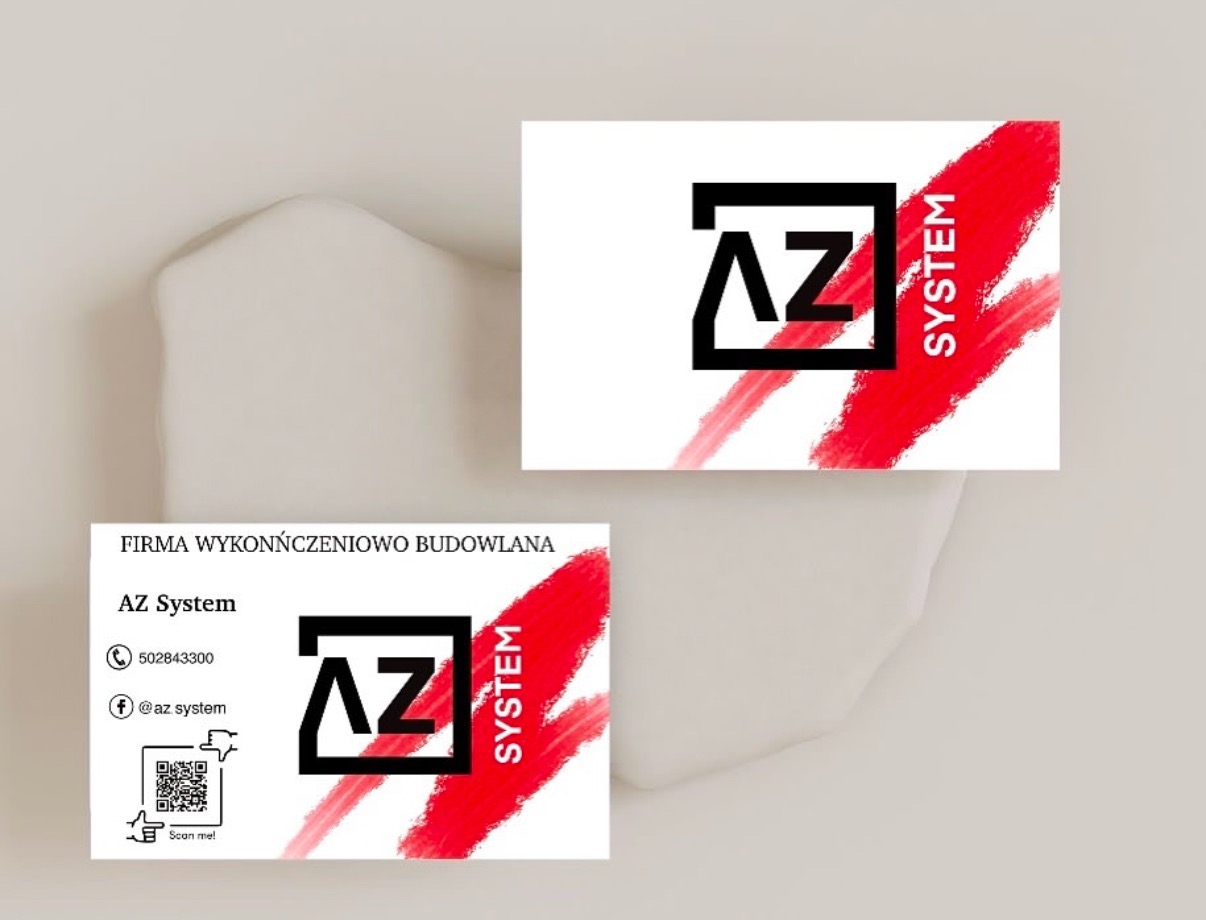 Dwie wizytówki firmy budowlanej AZ System na beżowym tle, z czarnym logo w kwadracie i czerwoną, rozmytą linią.