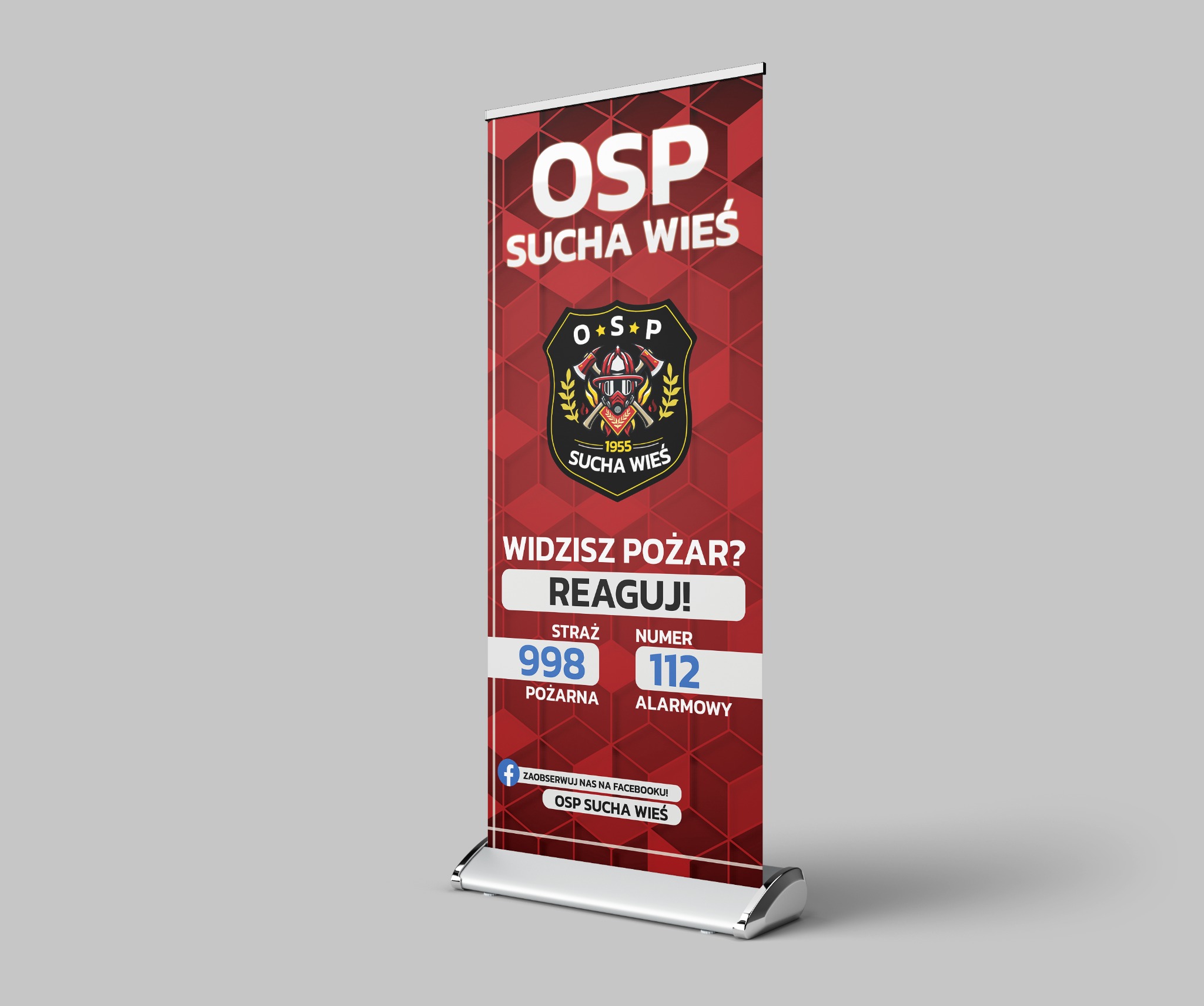 Roll-up reklamowy z grafiką i logo Ochotniczej Straży Pożarnej Sucha Wieś, zawierający numery alarmowe 998 i 112 oraz hasło 'Widzisz pożar? Reaguj!'.