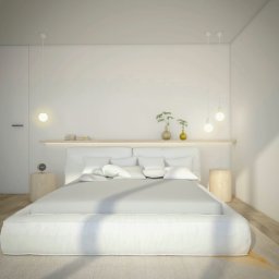 ART-DESIGN KAROL JURCZYK - Minimalistyczna sypialnia w bieli z kominkiem, drewnianą podłogą i abstrakcyjnym obrazem w ramie, oświetlona wiszącymi lampami i lampką nocną, z roślinami w wazonach na półce nad łóżkiem.