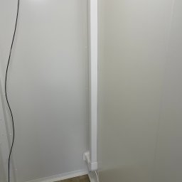 Chill Zone Mateusz Tomaszczuk - Wnętrze chłodni z widocznym odpływem podłogowym, białe panele ścienne i logo firmy Chill Zone w prawym dolnym rogu.