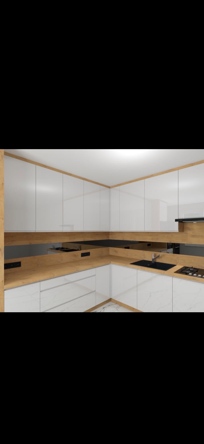 Nowoczesna kuchnia w kształcie litery U z białymi, błyszczącymi frontami szafek i drewnianym blatem z widocznymi gniazdkami elektrycznymi, czarny zlew i płyta grzewcza.