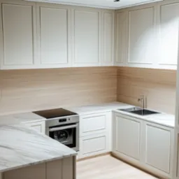 Nowoczesna kuchnia z białymi, frezowanymi szafkami, blatem z marmuru Carrara, płytą indukcyjną i piekarnikiem w zabudowie.