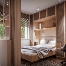 sueños studio - Wnętrze sypialni z elementami biura, drewniane panele z perforacją, łóżko z jasną pościelą, biurko z laptopem, okno z żaluzjami, pralka widoczna w tle.