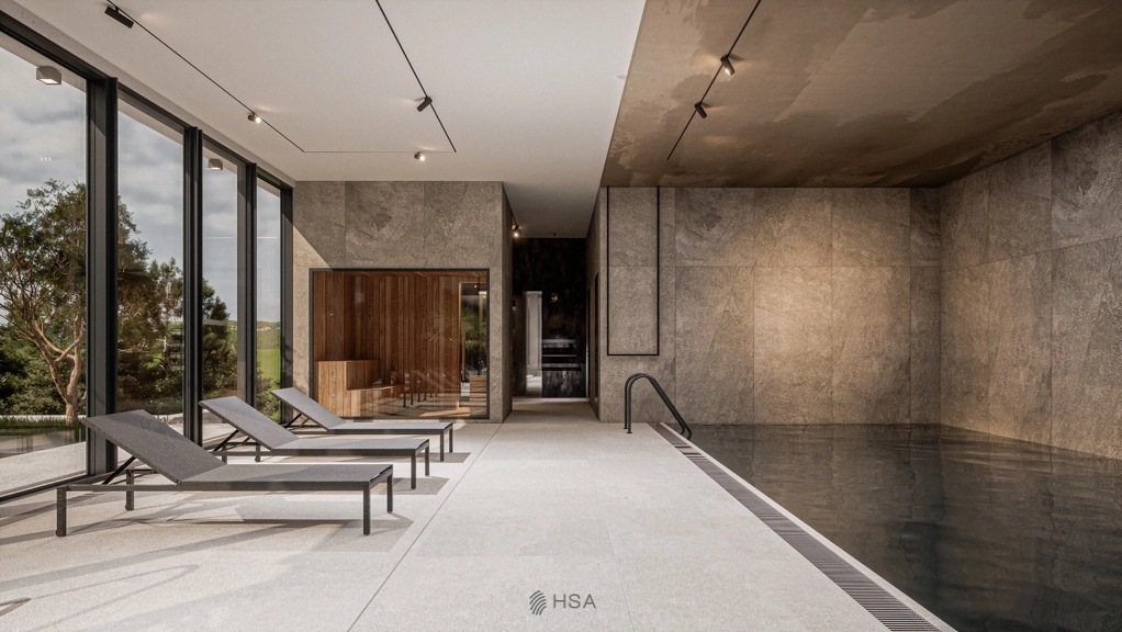 Wnętrze luksusowego spa z basenem i sauną, widoczne leżaki, duże okna z widokiem na zieleń, szara kamienna okładzina ścian i sufitu, minimalistyczne oświetlenie punktowe.
