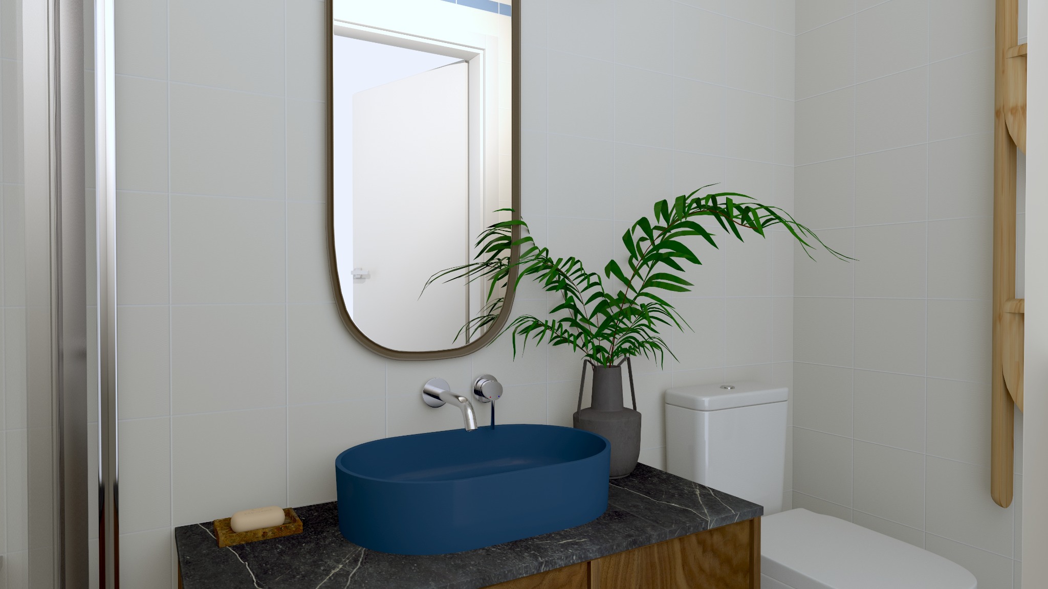 Nowoczesna łazienka z owalną, niebieską umywalką na blacie z ciemnego marmuru, lustrem w cienkiej ramie i zieloną rośliną w wazonie.