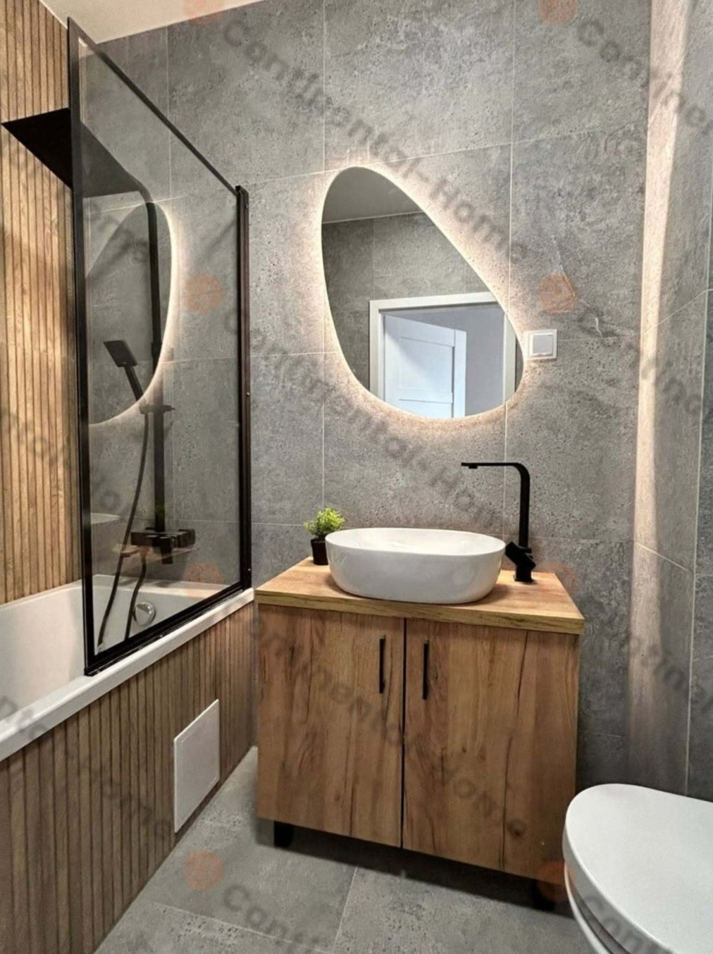 Nowoczesna łazienka w Katowicach z podświetlanym, asymetrycznym lustrem, umywalką nablatową na drewnianej szafce i kabiną prysznicową z czarnymi ramami.
