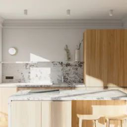 Jasna kuchnia z wyspą wykończoną marmurem, drewniane fronty szafek, minimalistyczny zlew i płyta grzewcza, dekoracje w postaci roślin w wazonach i obrazu na ścianie, krzesła barowe z jasnego drewna.