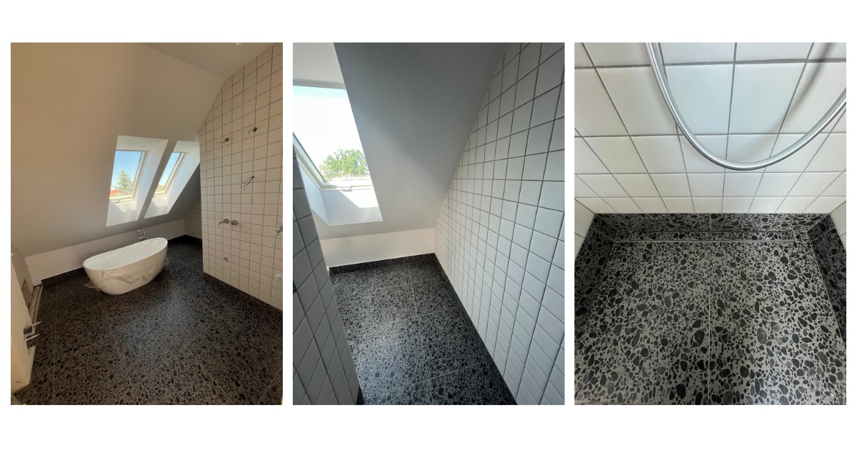 Wykończona łazienka na poddaszu z wanną wolnostojącą, szarym lastryko na podłodze i białymi kwadratowymi płytkami na ścianach. Widoczne okna dachowe i odpływ liniowy w strefie prysznica.