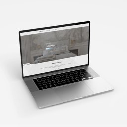 idesign JAROSŁAW JAWORSKI - Laptop wyświetla stronę internetową kandeladesign.pl z kolekcją MOBO, prezentującą aranżację sypialni z tapetą.