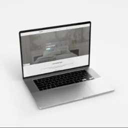 Laptop wyświetla stronę internetową kandeladesign.pl z kolekcją MOBO, prezentującą aranżację sypialni z tapetą.