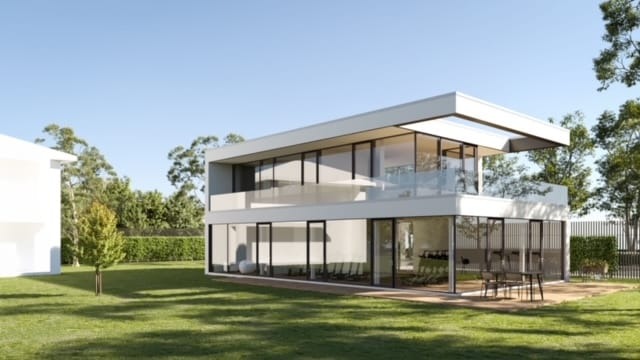 Wizualizacja nowoczesnego, dwukondygnacyjnego domu z dużymi przeszkleniami i balkonem w Gliwicach, otoczonego zielonym trawnikiem i drzewami w słoneczny dzień.