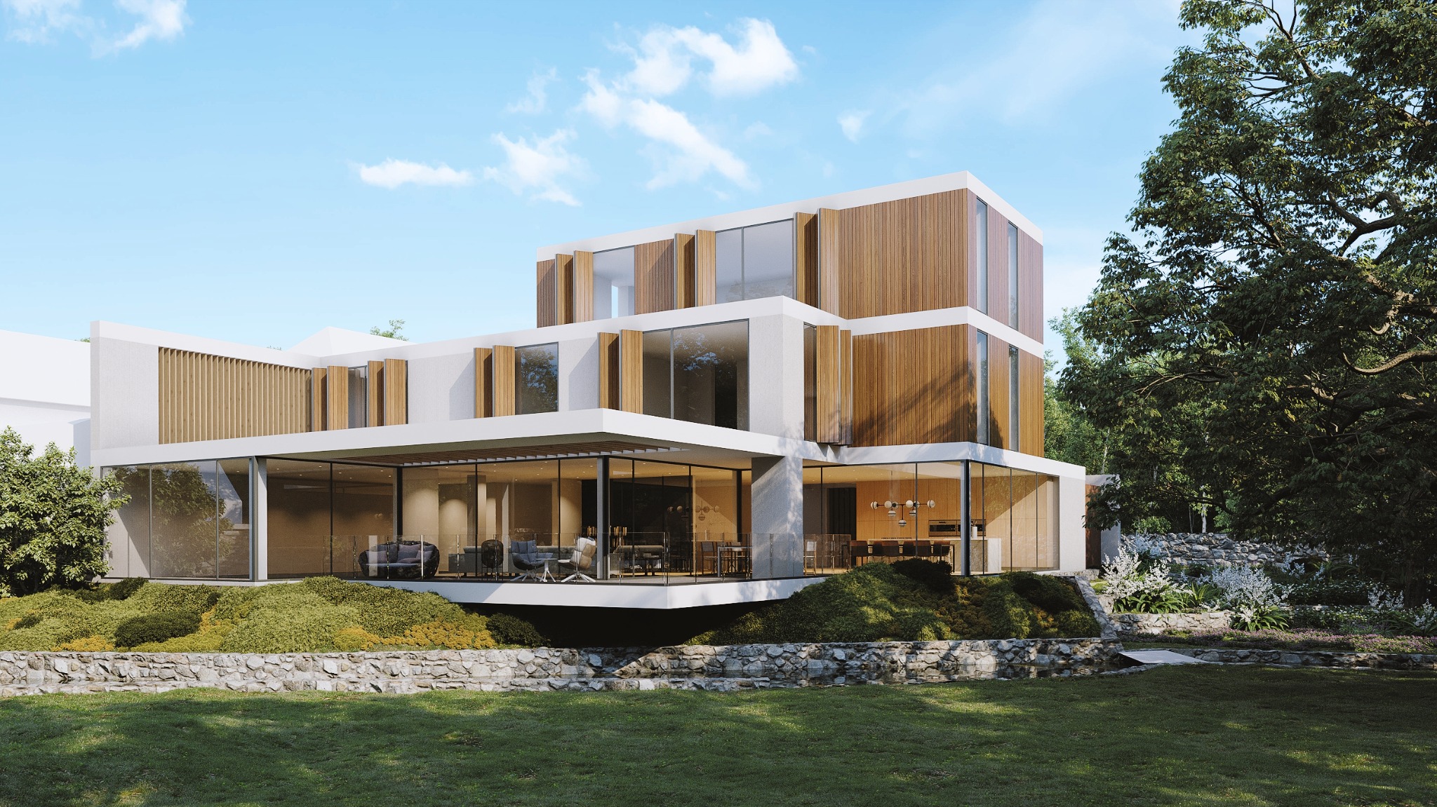 Nowoczesny, trzypiętrowy dom z dużymi przeszkleniami i drewnianą elewacją, otoczony zielenią i kamiennym murkiem oporowym.