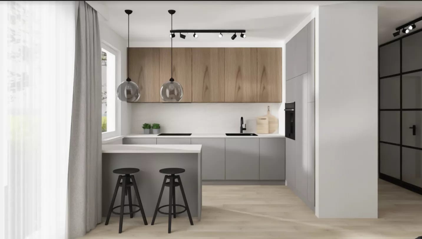 Nowoczesna kuchnia w odcieniach szarości i drewna z wyspą i dwoma czarnymi hokerami, oświetlona wiszącymi lampami kulami i reflektorami sufitowymi.