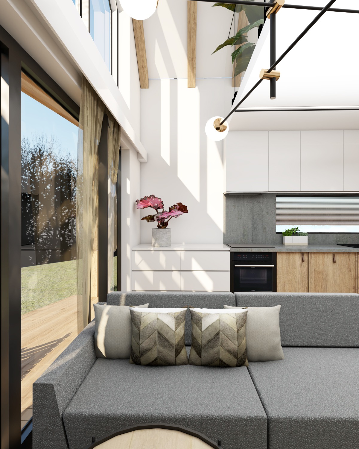 Wizualizacja wnętrza: szara sofa narożna z poduszkami w geometryczne wzory, na tle jasnej kuchni z drewnianymi szafkami i rośliną, duże okno z widokiem na zieleń.