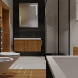 PRZESTRZEŃ SPOTKANIA Mariusz Kaczmarczyk - Nowoczesna łazienka z drewnianymi akcentami: podświetlana półka z ręcznikami, umywalka nablatowa z szafką, bidet i wanna, oświetlone lustro.