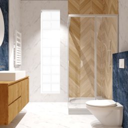 PRZESTRZEŃ SPOTKANIA Mariusz Kaczmarczyk - Nowoczesna łazienka z marmurowymi ścianami, drewnianą szafką pod umywalką, okrągłym lustrem, kabiną prysznicową ze szklanymi drzwiami i toaletą podwieszaną na tle ściany w kolorze granatowego marmuru.