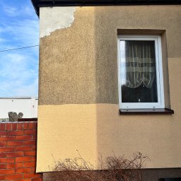 Firma Ogólnobudowlana Wiktor Marczak - Fragment elewacji budynku w trakcie prac: część ściany otynkowana, część pomalowana na dwa odcienie beżu. Widoczne okno z zasłonką i ceglany murek.