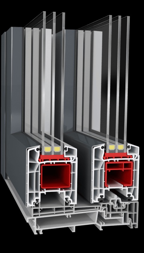 Przekrój poprzeczny dwukomorowej ramy okiennej z szarym profilem zewnętrznym i czerwonym profilem wewnętrznym, ukazujący budowę i uszczelnienia.