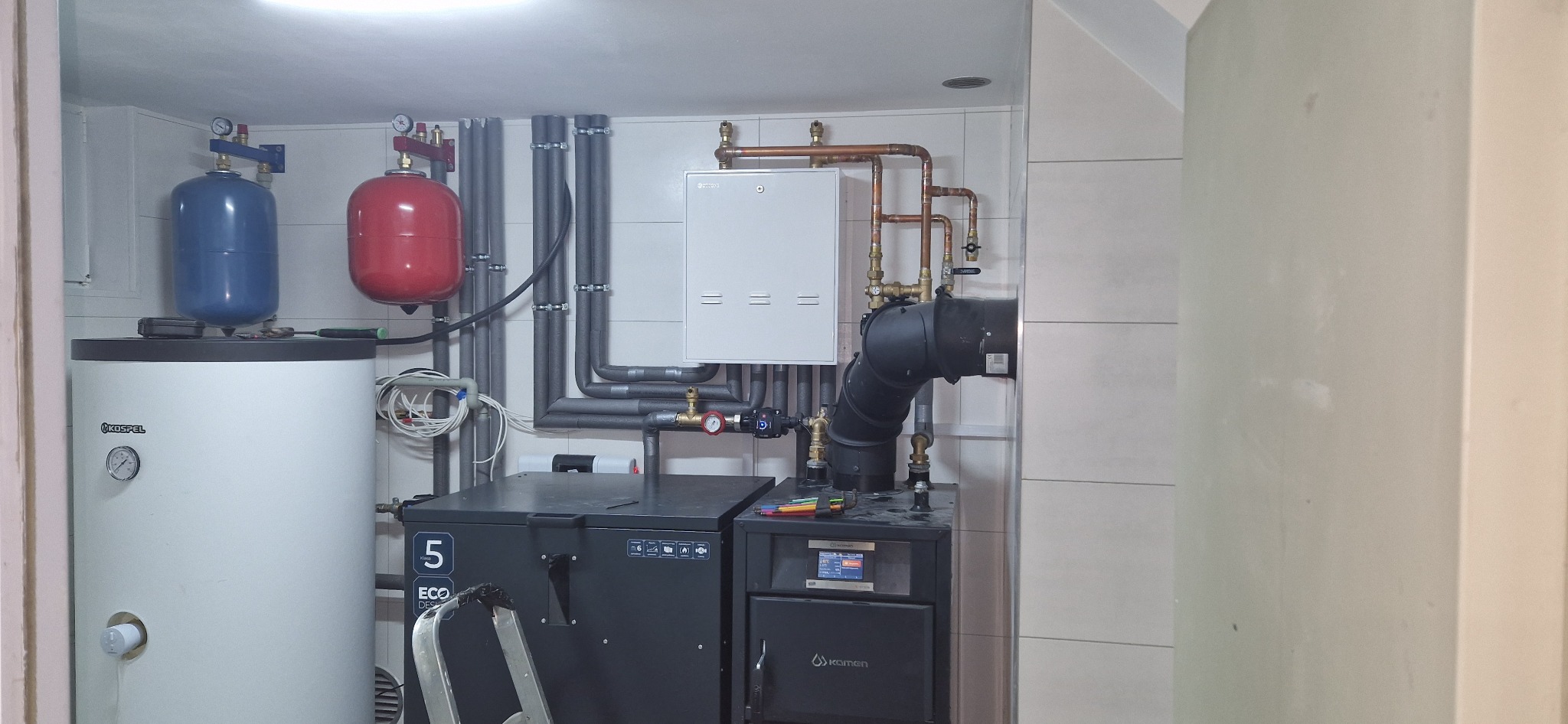 Kotłownia z zainstalowanym kotłem na paliwo stałe z podajnikiem, zasobnikiem CWU, naczyniami przeponowymi oraz instalacją grzewczą z rur stalowych.