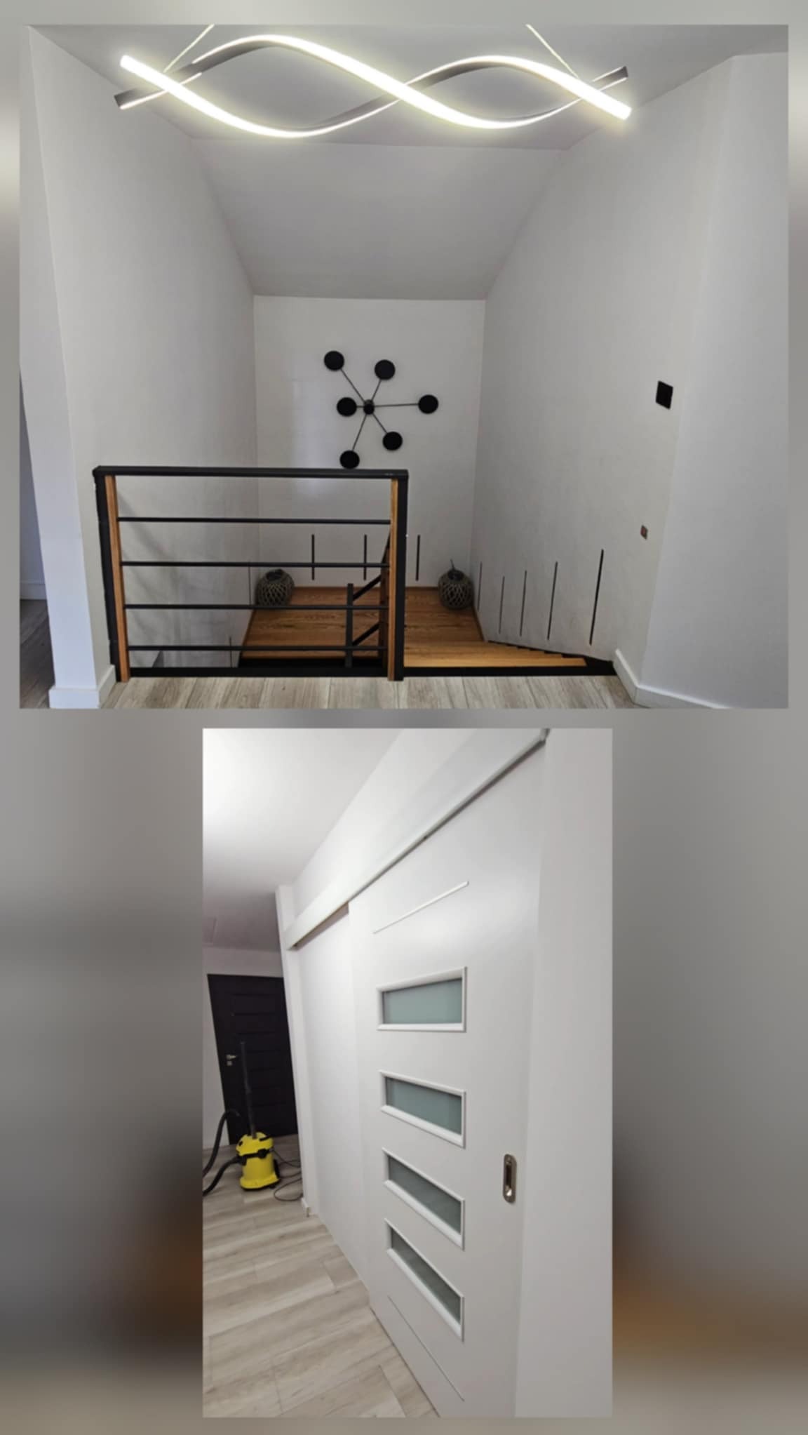Nowoczesne wykończenie wnętrza: białe ściany, drewniane schody z czarną balustradą i designerska lampa sufitowa. Widoczna biała przesuwna brama z przeszkleniami.